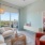 a living room with a large window, a chair and a couch