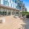 a deck with chairs and a building