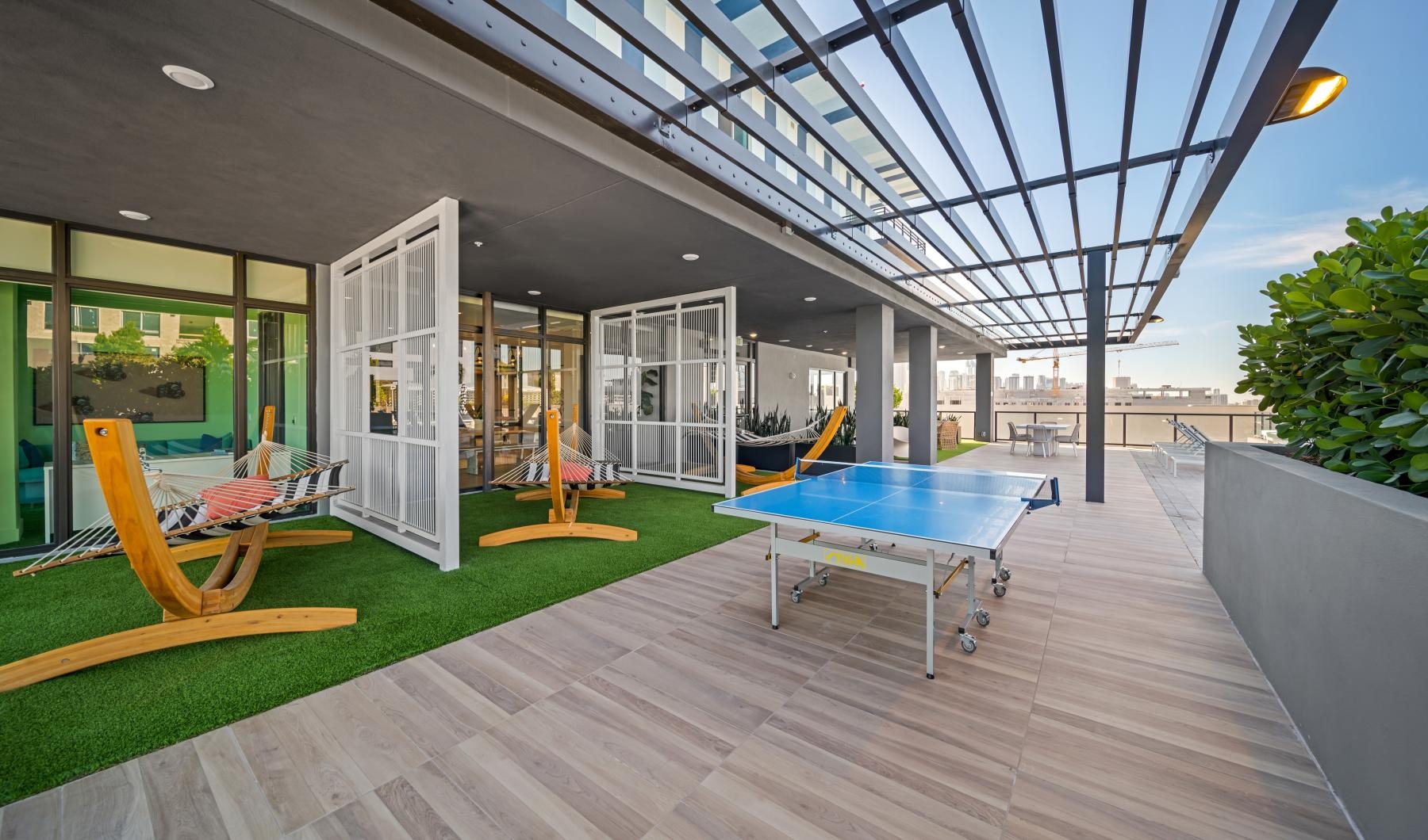 State-of-the-art amenities a pingpong table on a deck with seating areas