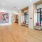 a clubhouse room with wood floors and wall art
