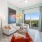 a living room with a chair, couch and a large window